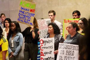 Group of people holding signs to end Chicago's gang database